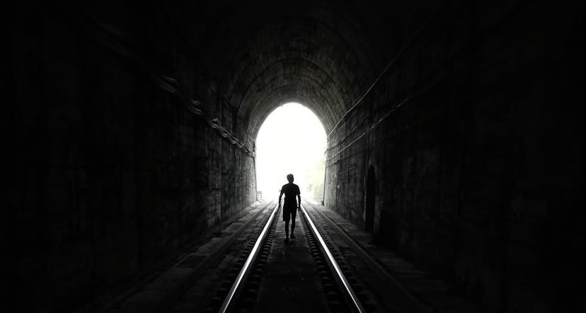 person walking through a tunnel